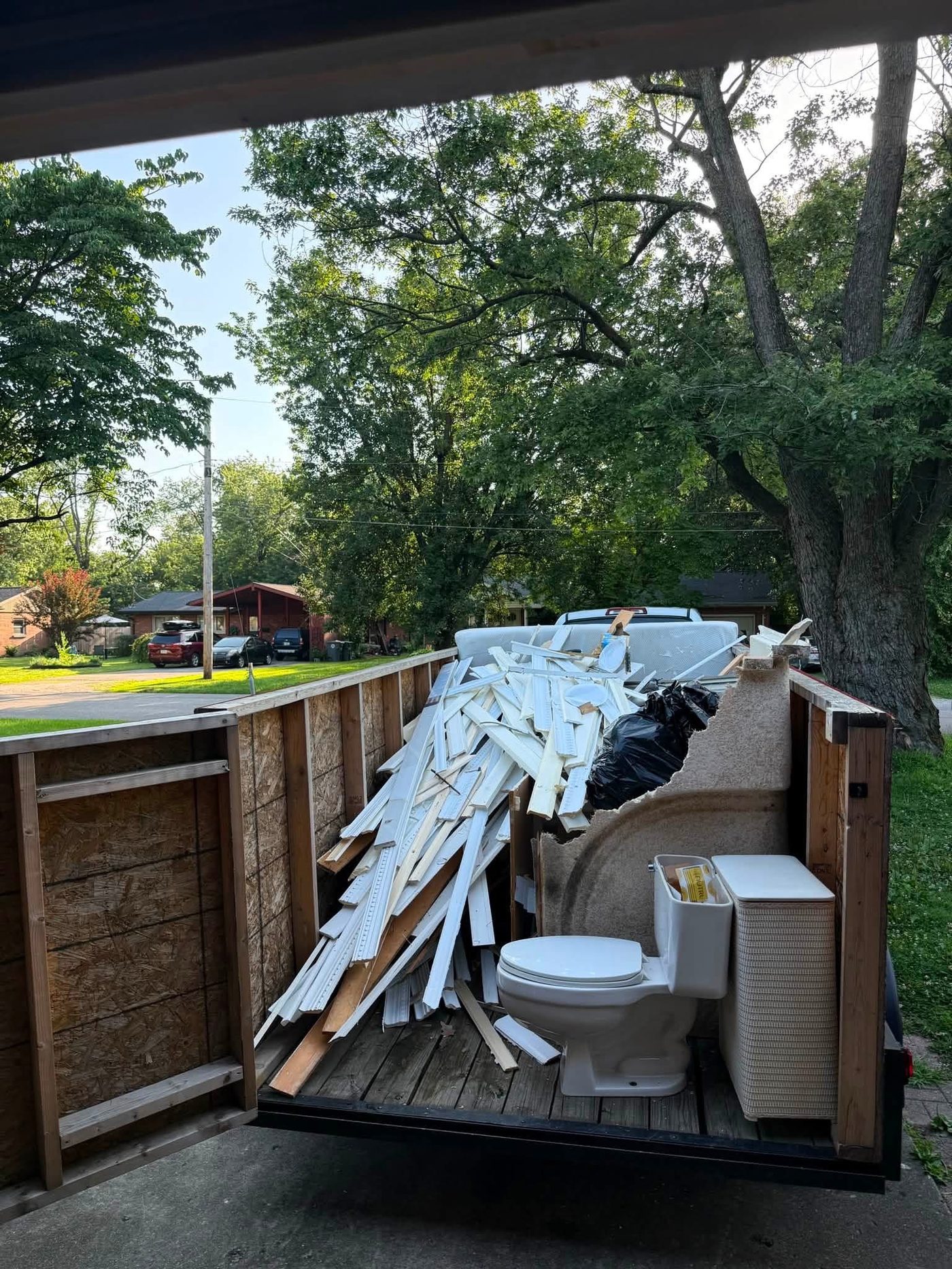 Enclosed trailer loaded with furniture and household junk